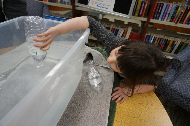 ...but tip the bottle & you can see air! The water goes in the bottle as the air escapes.
