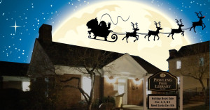 Santa and reindeer fly over the Pawling Library at night.