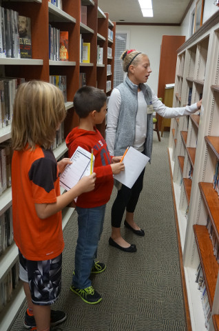 Miss Alibitress continues to browse movies while she answers the questions.