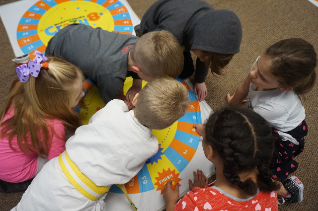 Teams work together to figure out the best math strategy to use.